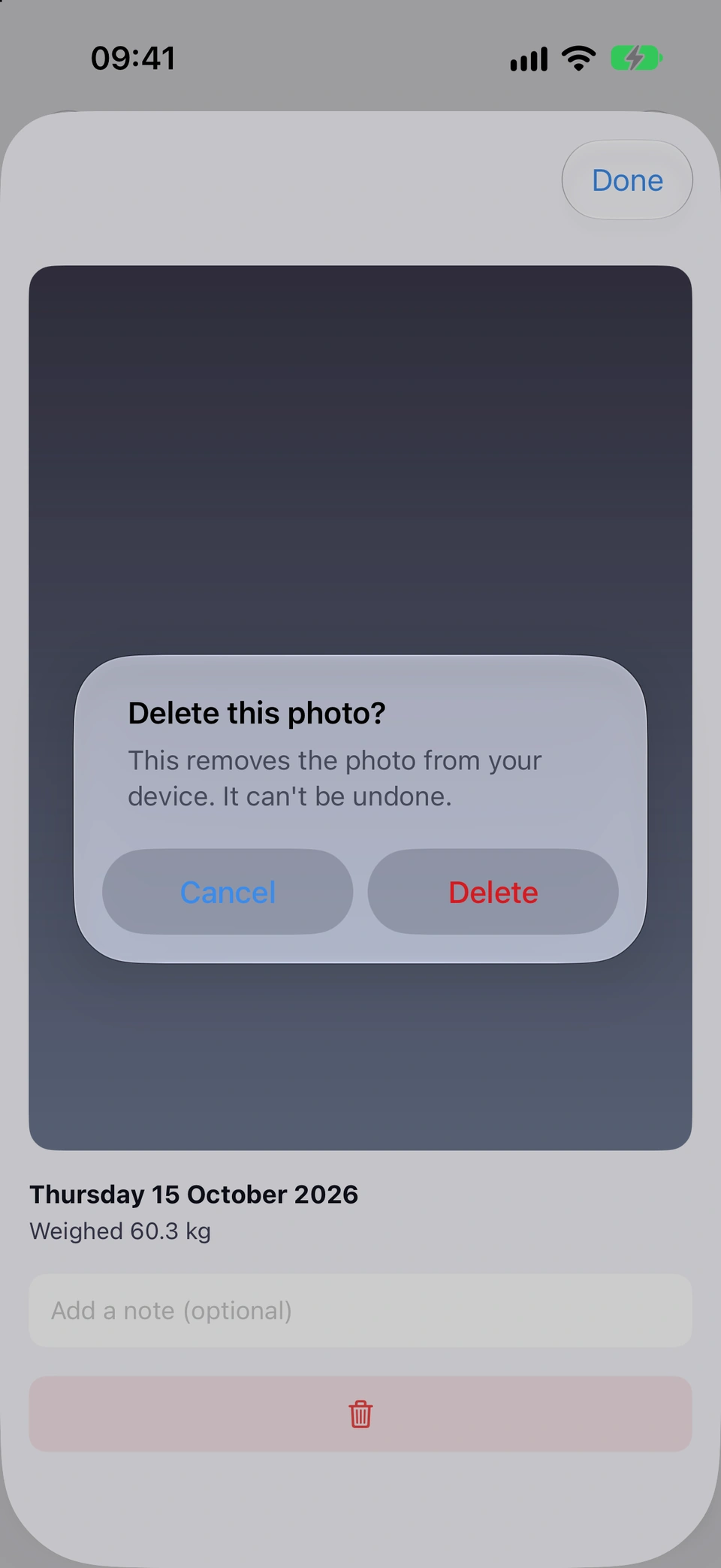 A progress photo opened from the Photos tab, dated Thursday 15 October 2026 and weighed 60.3 kg, with the alert Delete this photo? This removes the photo from your device. It can't be undone. and the buttons Cancel and Delete.