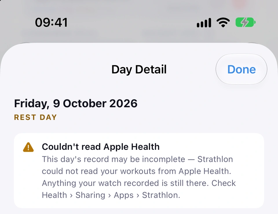 The top of Day Detail for Friday 9 October with an amber notice, Couldn't read Apple Health: this day's record may be incomplete because Strathlon could not read your workouts from Apple Health; anything your watch recorded is still there; check Health › Sharing › Apps › Strathlon.