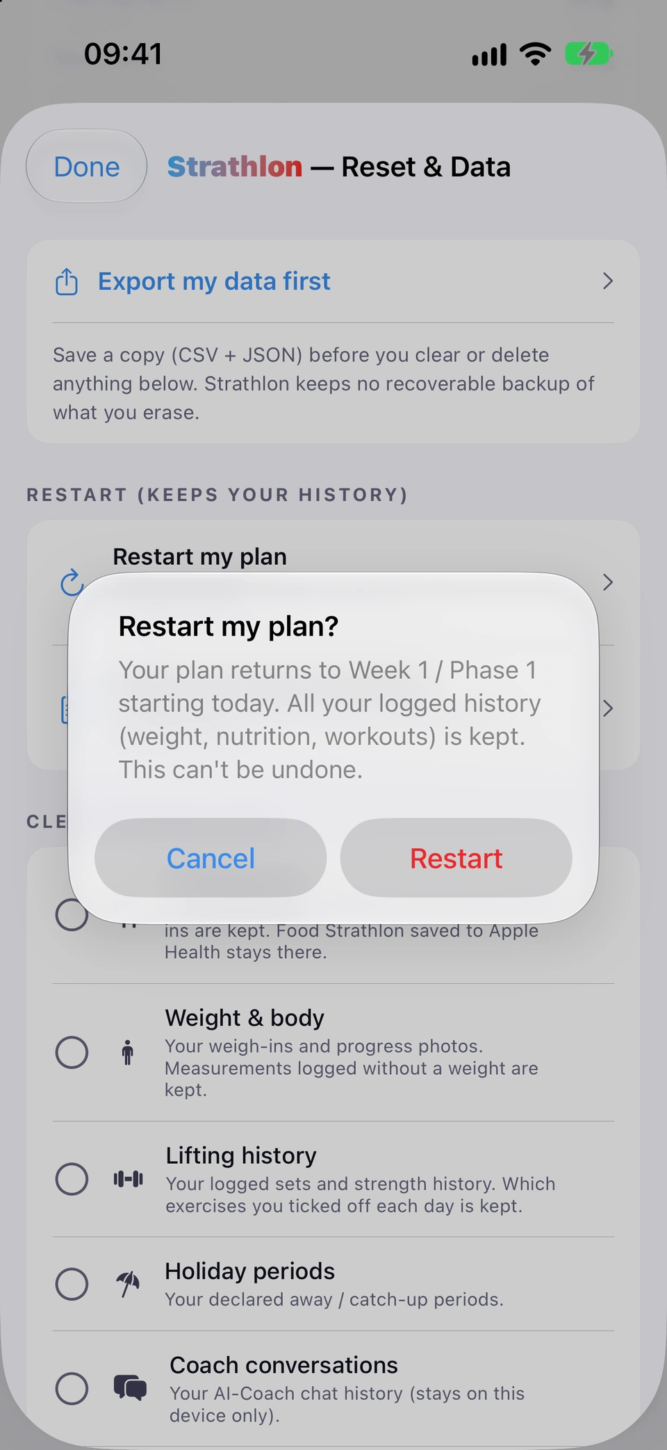 Reset & Data with the Restart my plan? confirmation open: your plan returns to Week 1 / Phase 1 starting today, all your logged history (weight, nutrition, workouts) is kept, and this can't be undone, with Cancel and Restart.