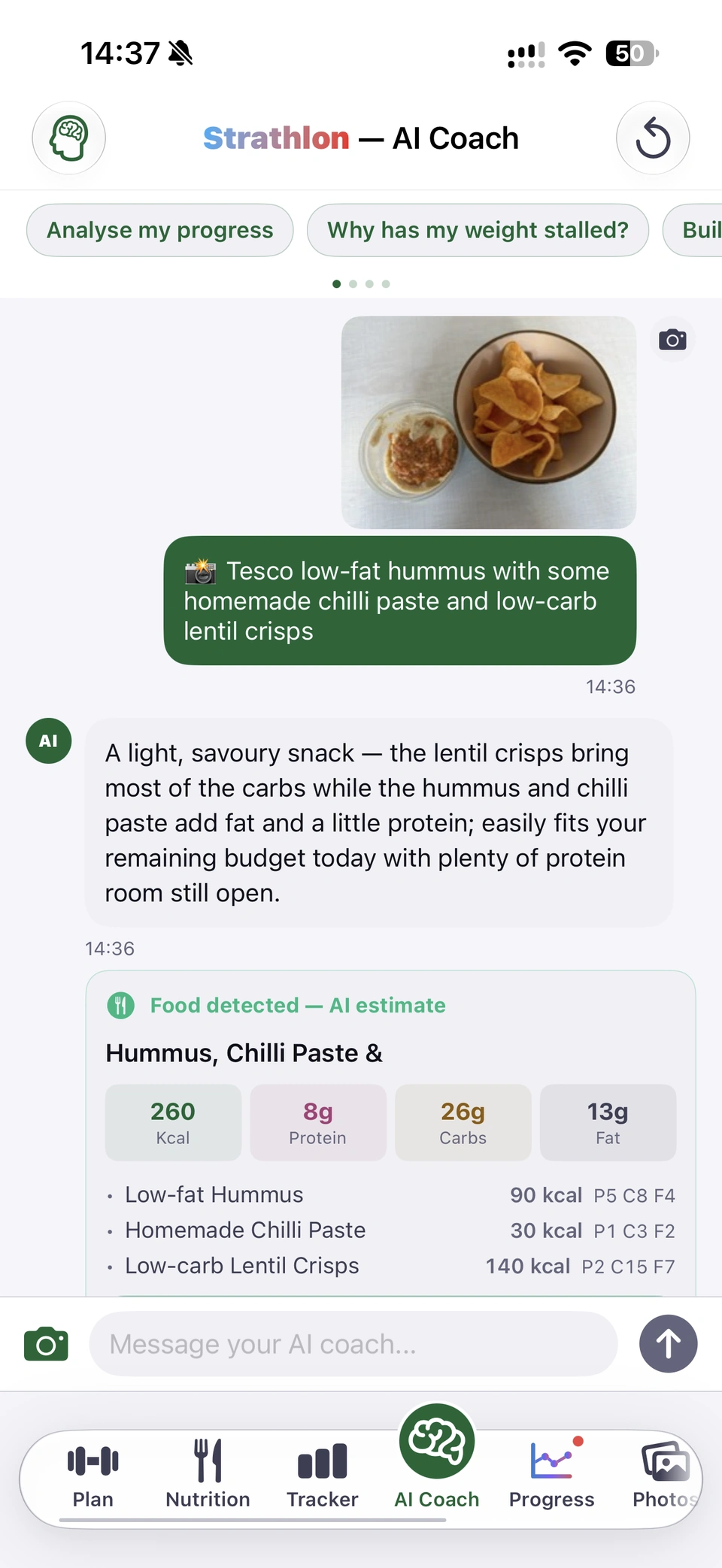 Strathlon AI Coach, light mode, one conversation scrolling. The user sends a photo of a snack, hummus with chilli paste and a bowl of lentil crisps, with the message: Tesco low-fat hummus with some homemade chilli paste and low-carb lentil crisps. The coach replies that it is a light, savoury snack that easily fits the day's remaining budget, and shows a Food detected, AI estimate card: 260 kcal, 8 g protein, 26 g carbs, 13 g fat (low-fat hummus 90 kcal, homemade chilli paste 30 kcal, low-carb lentil crisps 140 kcal), logged to today's tracker. The user says: I like this food combo. The coach calls it a good snack choice, with 75 g protein, 239 g carbs and 37 g fat still left today, and suggests a boiled egg or an extra dollop of hummus next time for more protein. Under the answer the coach shows what it has remembered: Your coach picked this up, hummus, chilli paste and lentil crisps, enjoys this as a regular snack combo; it saves tomorrow, and you can change it before then.